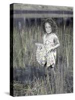 Little Girl Standing in Pond Surrounded by Tall Grass-Nora Hernandez-Stretched Canvas