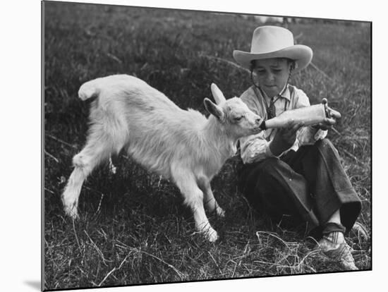 Little White Goat Being Fed from Bottle by Little Boy, at White Horse Ranch-William C^ Shrout-Mounted Photographic Print