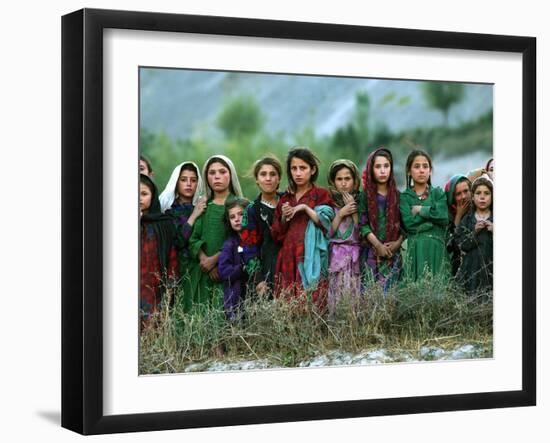 Local Girls Look at a U.N. Workers Unloading Ballot Kits from a U.N. Helicopter-null-Framed Premium Photographic Print