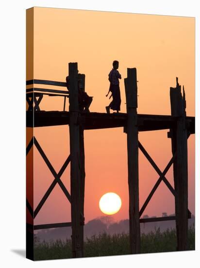 Local Man Walking on the Famous U Bein Teak Bridge at Sunset, Near Mandalay, Myanmar (Burma), Asia-Lee Frost-Stretched Canvas