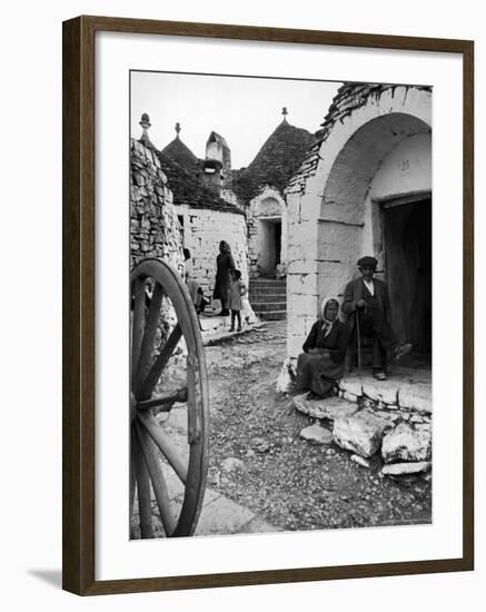 Locals Outside Trulli Homes Made from Limestone Boulders and Feature Conical or Domed Roofs-Alfred Eisenstaedt-Framed Photographic Print