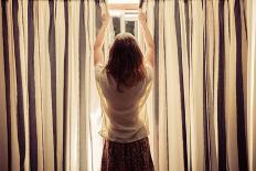 A Young Woman is Opening the Curtains at Sunrise-lolostock-Photographic Print