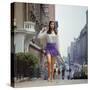 Long Hair Woman with short skirt, lace top and sandals walking up street in "New York Look" fashion-Vernon Merritt III-Stretched Canvas