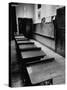 Looking Down Row of Empty Scarred Old Fashioned Desks in Schoolroom-Walter Sanders-Stretched Canvas