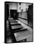 Looking Down Row of Empty Scarred Old Fashioned Desks in Schoolroom-Walter Sanders-Framed Stretched Canvas