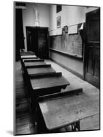 Looking Down Row of Empty Scarred Old Fashioned Desks in Schoolroom-Walter Sanders-Mounted Photographic Print