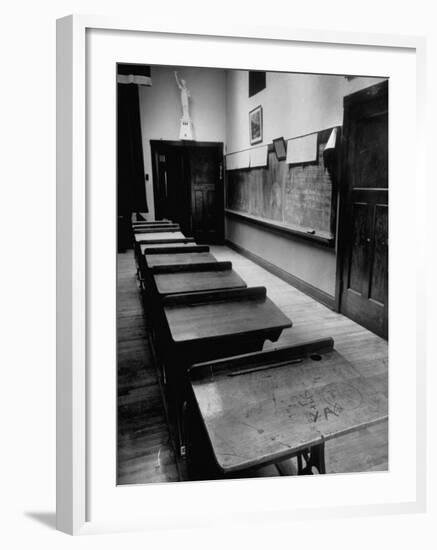 Looking Down Row of Empty Scarred Old Fashioned Desks in Schoolroom-Walter Sanders-Framed Photographic Print