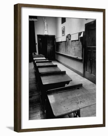 Looking Down Row of Empty Scarred Old Fashioned Desks in Schoolroom-Walter Sanders-Framed Photographic Print