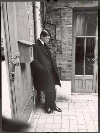 Christian Dior's Successor Yves Saint Laurent Standing Alone After Attending Dior's Funeral