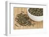 Loose Leaf Sencha Green Tea in a White China Cup and Spilled over Bamboo Mat-PixelsAway-Framed Photographic Print