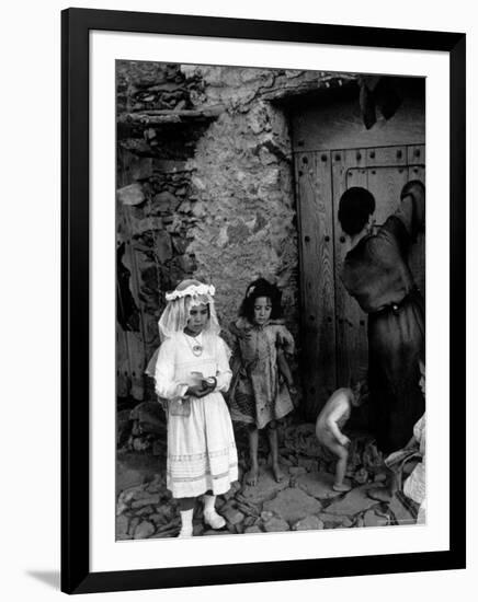 Lorenza Curiel in White First Communion Dress Waiting for Mother to Lock Door-W^ Eugene Smith-Framed Photographic Print