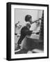 Lori Mckone in Bathroom Reaching for Toothbrush-null-Framed Photographic Print