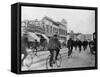 Los Angeles Police Officers Bicycling Past Broadway Storefronts-null-Framed Stretched Canvas