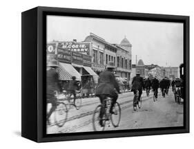 Los Angeles Police Officers Bicycling Past Broadway Storefronts-null-Framed Stretched Canvas