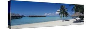 Lounge Chair under a Beach Umbrella, Moana Beach, Bora Bora, French Polynesia-null-Stretched Canvas