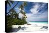 Lounge chairs under shade of umbrella on tropical beach, Maldives, Indian Ocean, Asia-Sakis Papadopoulos-Stretched Canvas