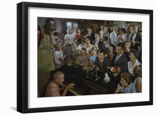 Low-Angle View of a Group of People as They Sing Along with a Pianist in a Unidentified Bar, 1959-Yale Joel-Framed Photographic Print