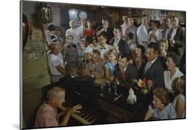 Low-Angle View of a Group of People as They Sing Along with a Pianist in a Unidentified Bar, 1959-Yale Joel-Mounted Photographic Print