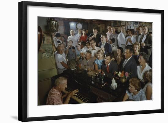 Low-Angle View of a Group of People as They Sing Along with a Pianist in a Unidentified Bar, 1959-Yale Joel-Framed Photographic Print