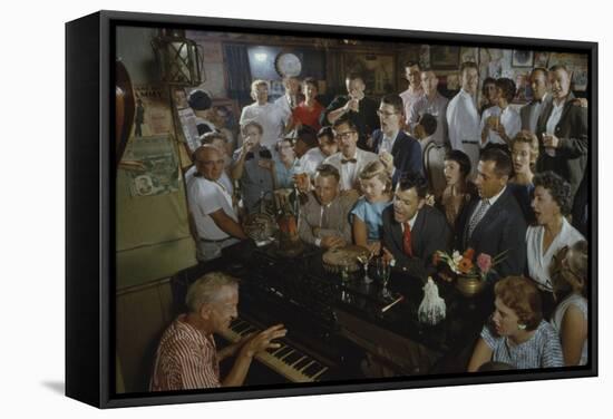 Low-Angle View of a Group of People as They Sing Along with a Pianist in a Unidentified Bar, 1959-Yale Joel-Framed Stretched Canvas