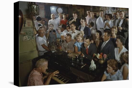 Low-Angle View of a Group of People as They Sing Along with a Pianist in a Unidentified Bar, 1959-Yale Joel-Stretched Canvas