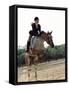Low Angle View of a Jockey And a Horse Jumping Over a Hurdle-null-Framed Stretched Canvas