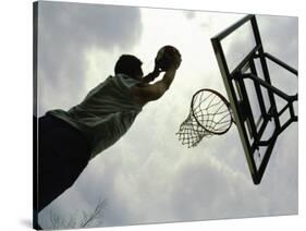 Low Angle View of a Man Shooting a Basket-null-Stretched Canvas