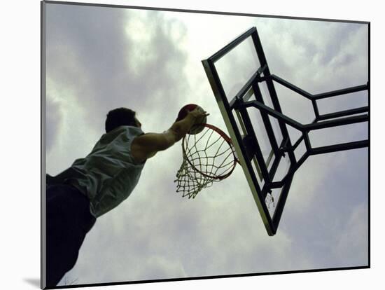 Low Angle View of a Man Shooting a Basket-null-Mounted Photographic Print