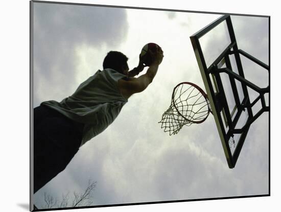 Low Angle View of a Man Shooting a Basket-null-Mounted Photographic Print