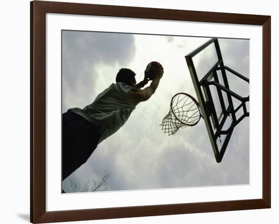 Low Angle View of a Man Shooting a Basket-null-Framed Photographic Print