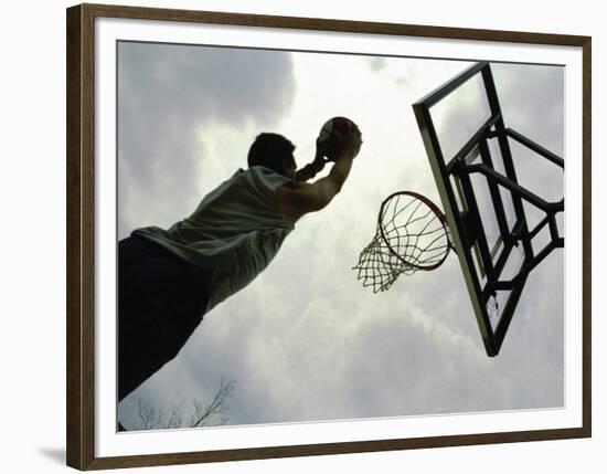 Low Angle View of a Man Shooting a Basket-null-Framed Photographic Print