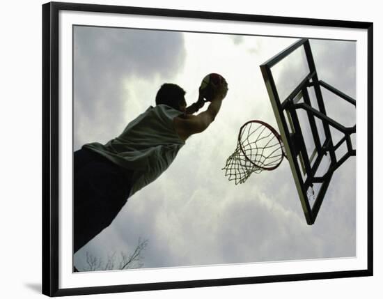 Low Angle View of a Man Shooting a Basket-null-Framed Photographic Print