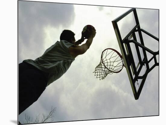 Low Angle View of a Man Shooting a Basket-null-Mounted Photographic Print