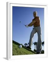 Low Angle View of a Senior Man Swinging a Golf Club-null-Framed Premium Photographic Print
