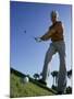 Low Angle View of a Senior Man Swinging a Golf Club-null-Mounted Premium Photographic Print