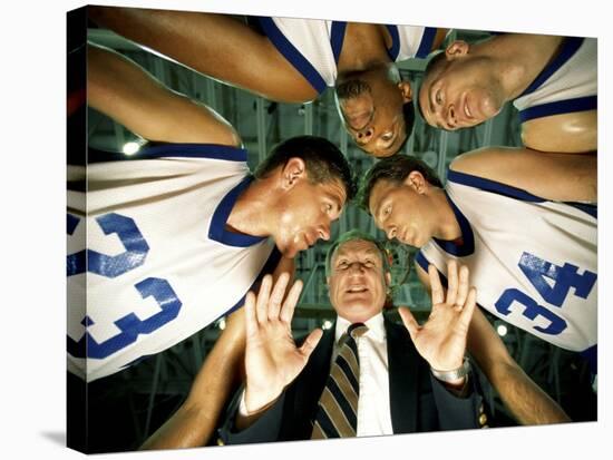 Low Angle View of a Team and Their Coach in a Huddle-null-Stretched Canvas