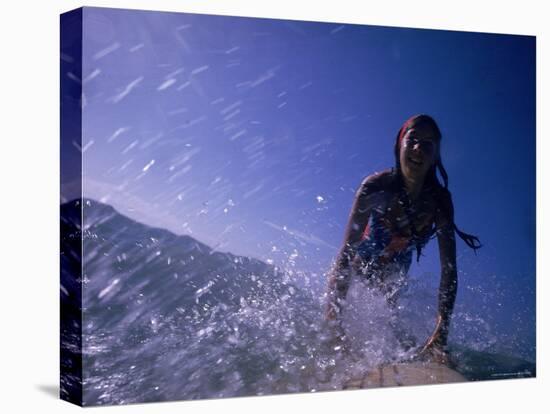 Low Angle View of a Teenage Girl Riding a Surfboard-George Silk-Stretched Canvas