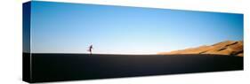 Low Angle View of a Woman Running in the Desert, Great Sand Dunes National Monument, Colorado, USA-null-Stretched Canvas