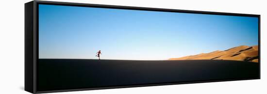 Low Angle View of a Woman Running in the Desert, Great Sand Dunes National Monument, Colorado, USA-null-Framed Stretched Canvas