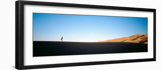 Low Angle View of a Woman Running in the Desert, Great Sand Dunes National Monument, Colorado, USA-null-Framed Premium Photographic Print