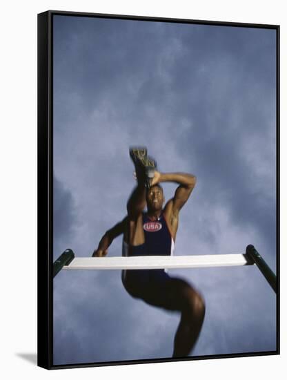 Low Angle View of a Young Man Jumping over a Hurdle-null-Framed Stretched Canvas