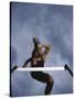 Low Angle View of a Young Man Jumping over a Hurdle-null-Stretched Canvas