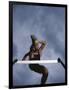 Low Angle View of a Young Man Jumping over a Hurdle-null-Framed Photographic Print