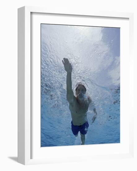Low Angle View of a Young Man Swimming Underwater-null-Framed Photographic Print