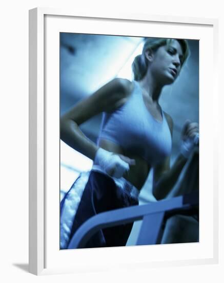 Low Angle View of a Young Woman Running on a Treadmill-null-Framed Photographic Print