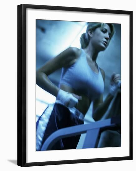 Low Angle View of a Young Woman Running on a Treadmill-null-Framed Photographic Print