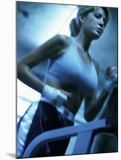 Low Angle View of a Young Woman Running on a Treadmill-null-Mounted Photographic Print