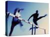 Low Angle View of Athletes Jumping over Hurdles-null-Stretched Canvas