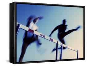 Low Angle View of Athletes Jumping over Hurdles-null-Framed Stretched Canvas