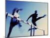 Low Angle View of Athletes Jumping over Hurdles-null-Mounted Photographic Print